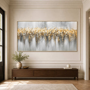 Gold framed panoramic painting above a wooden console and ceramic vase in a hallway.