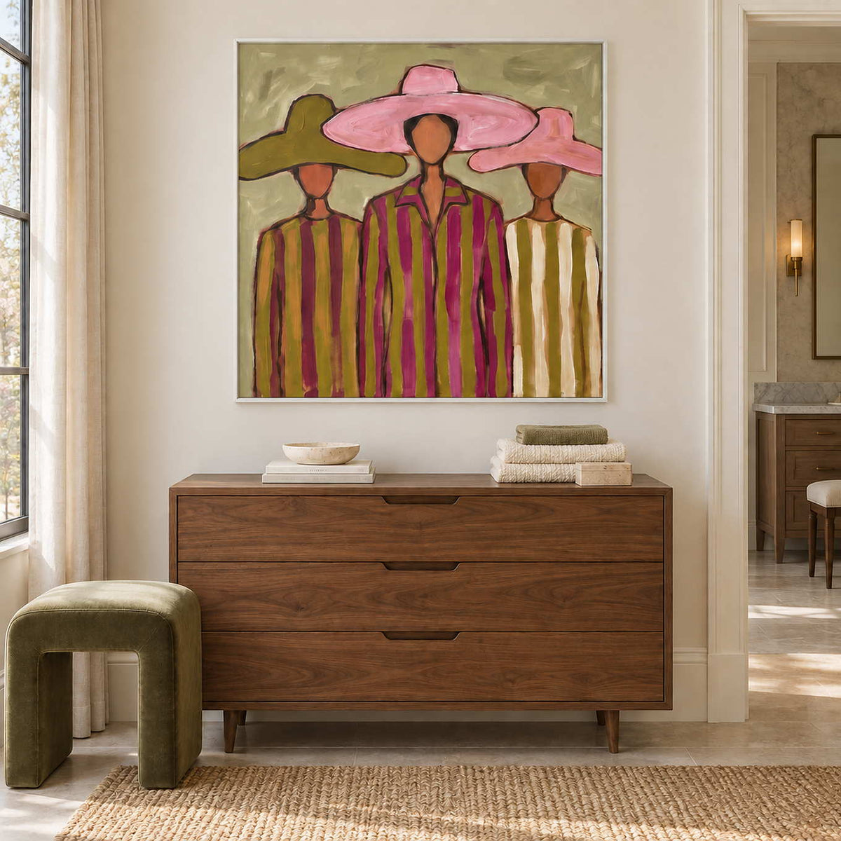 A Meeting in Style in a white frame above a wood cabinet with folded towels beside a bathroom vanity.