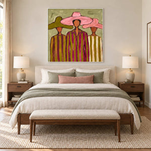 A Meeting in Style in a white frame above a cream bed with sage bedding and a pink cushion.