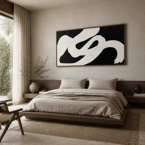 Wood framed sweeping white abstract artwork above a low bed in a neutral bedroom.