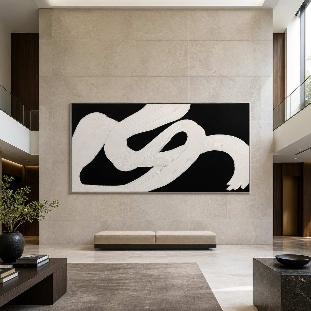 Silver framed panoramic abstract painting above a bench in a tall hotel lobby.