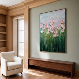 Wood framed pink flower painting above a walnut cabinet in a sage green study.