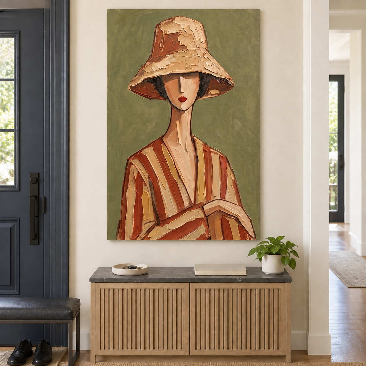 Tall olive portrait above a slatted wooden entryway cabinet and a small plant.