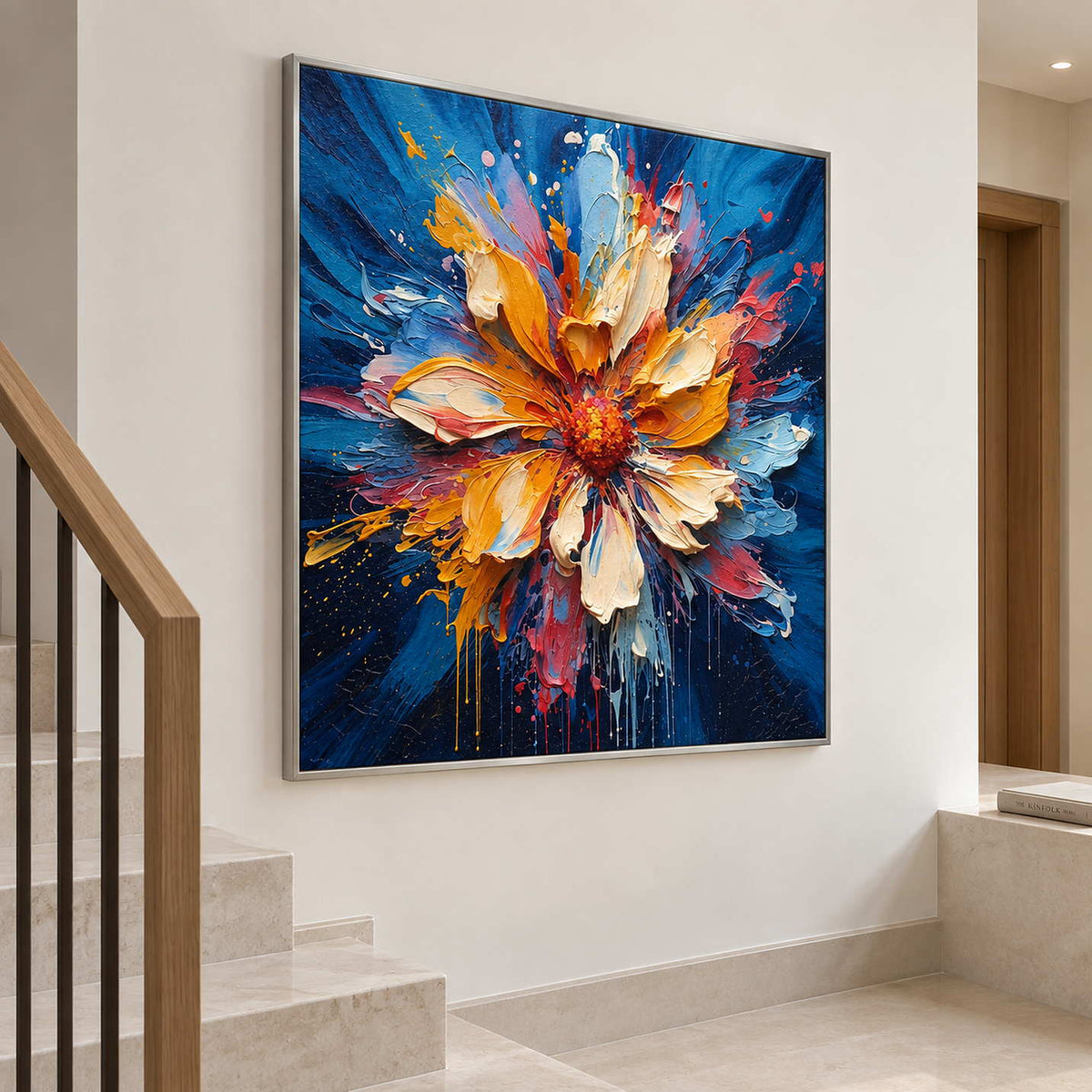 Angled view of the blue floral painting on a wall beside pale stairs and a wood handrail.