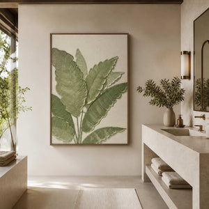 Wood-framed green leaf wall art beside a stone vanity in a serene bathroom.
