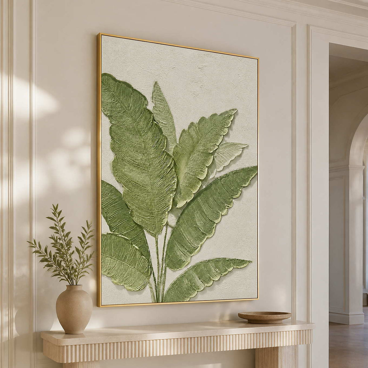 Gold-framed botanical wall art above a floating console in a light-filled hallway.