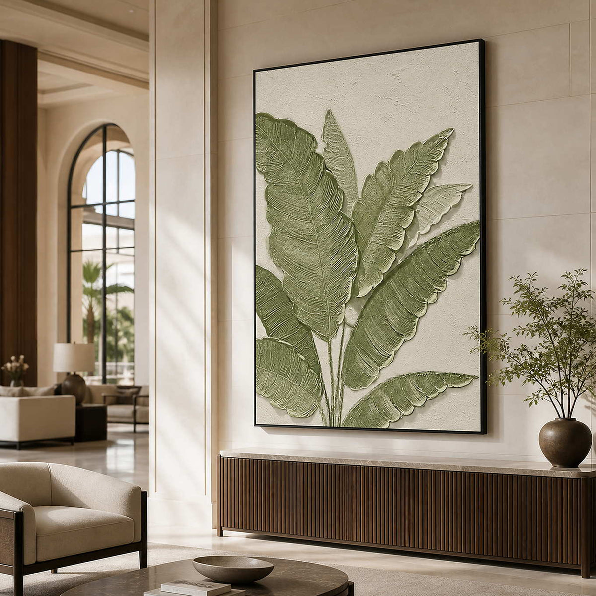 Black-framed botanical wall art above a console in an elegant hotel lobby.