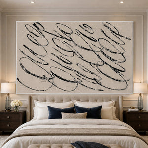 White framed black loop wall art above a softly upholstered cream bed.