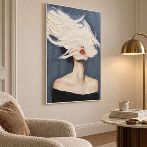 Portrait with coral lips beside a cream reading chair and gold-toned floor lamp.