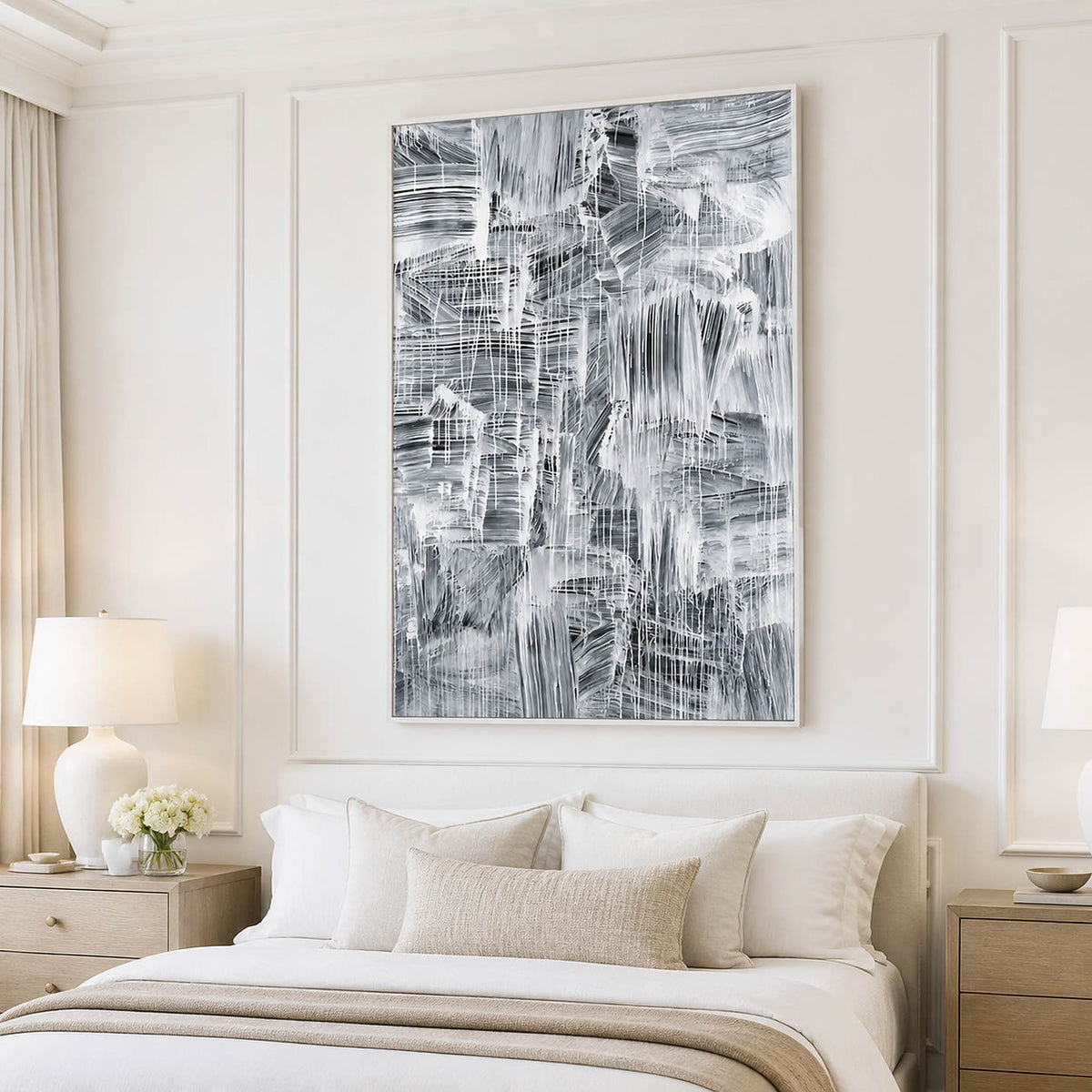 White-framed vertical abstract painting above a neutral upholstered bed.