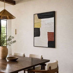 Black-framed A Pause in the Afternoon beside a wood dining table under a brass pendant light.