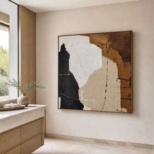 Brown-and-white abstract artwork beside a pale countertop and wooden vanity.