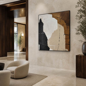 Large earthy abstract painting in a lounge with cream chairs and dark wood panels.