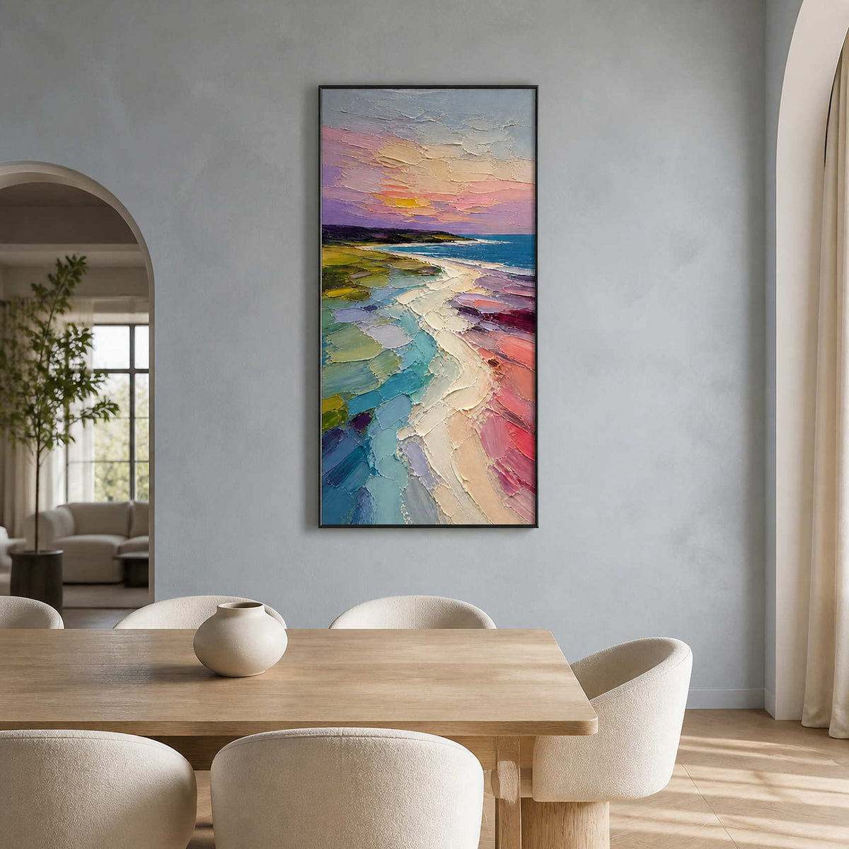 Pastel sunset coastal painting displayed in a light wood dining room.