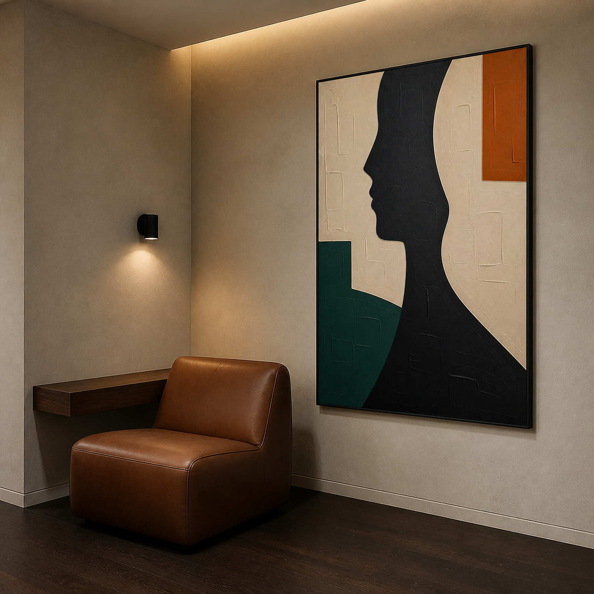 Modern profile wall art beside a leather chair in a sitting nook.