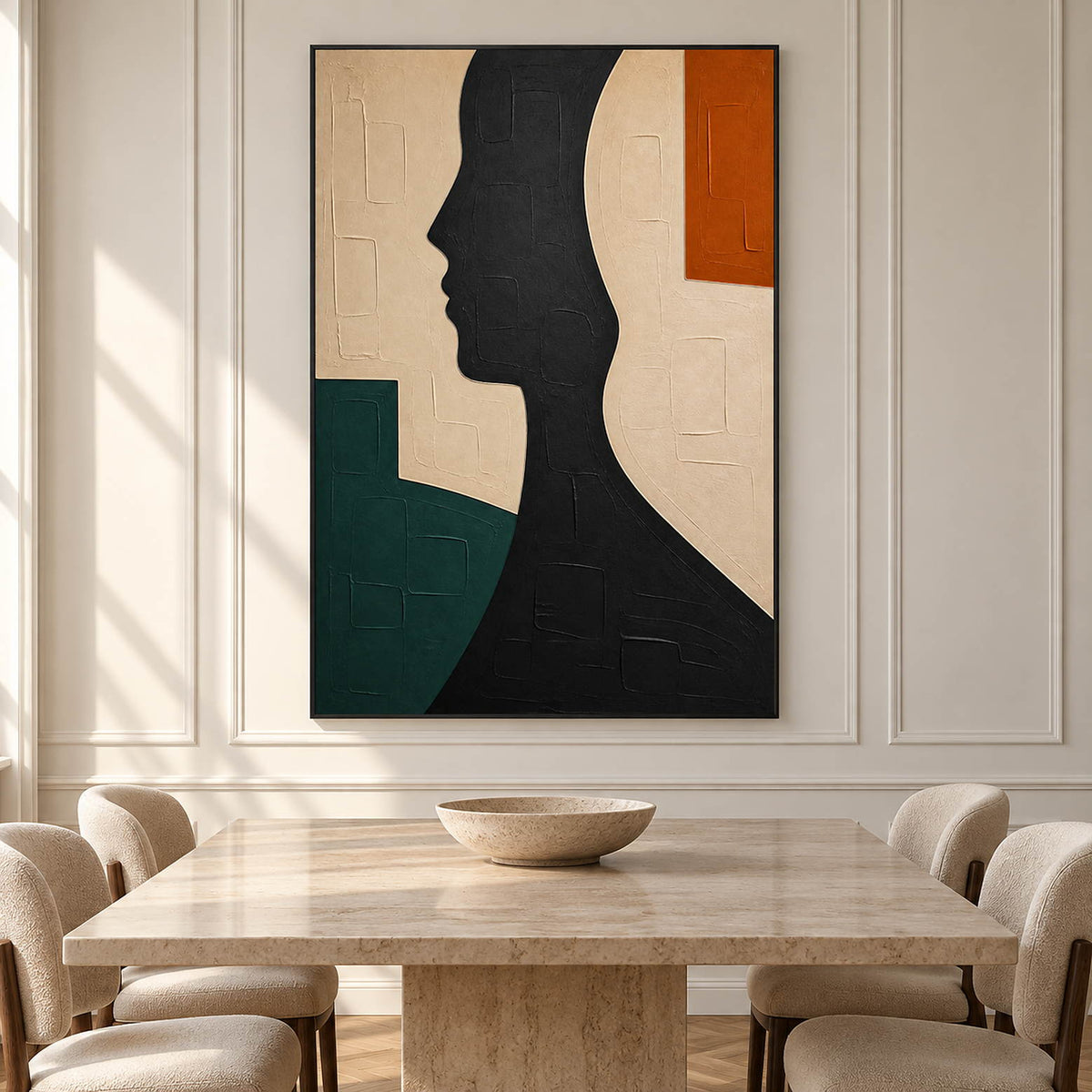 Hand-painted black profile canvas with ivory, green, and orange forms, displayed in a dining room in a black frame.