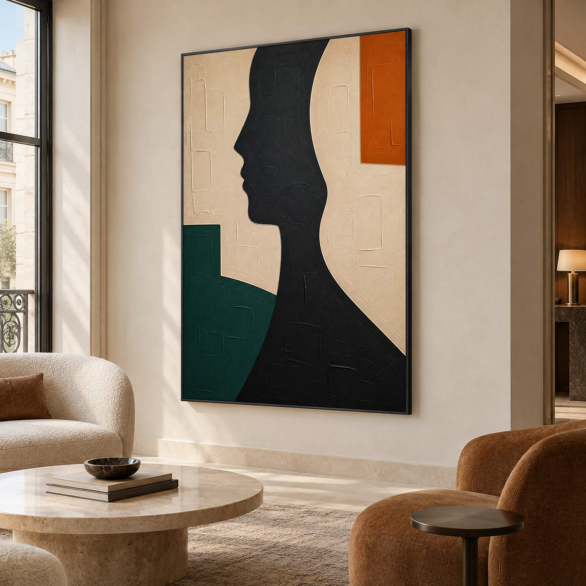 Hand-painted black profile canvas with ivory, green, and orange forms, displayed in a hotel lounge in a black frame.