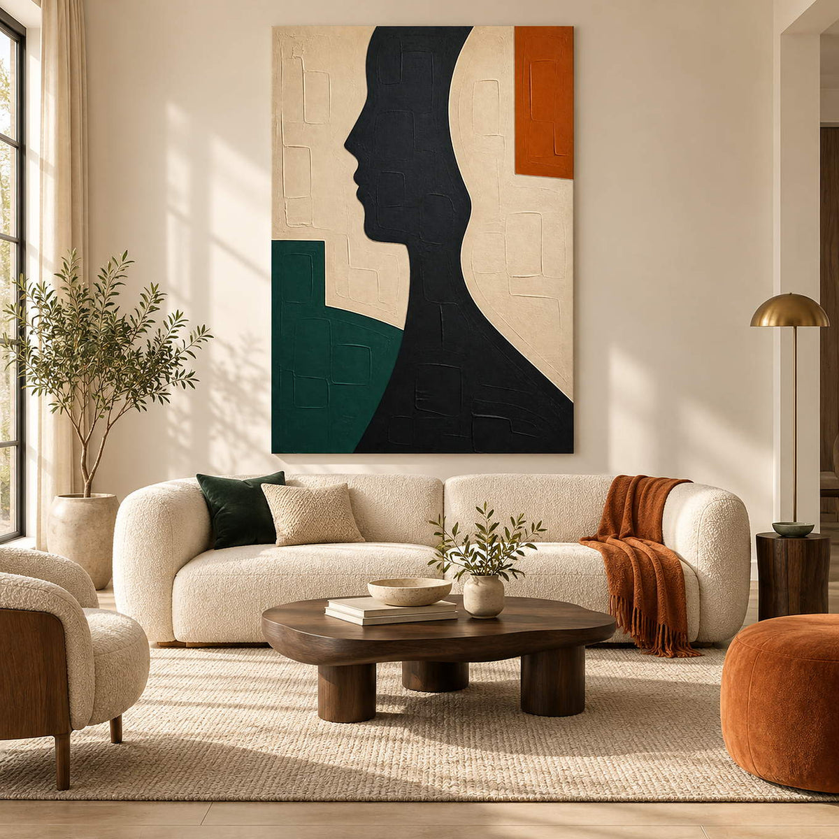 Hand-painted black profile canvas with ivory, green, and orange forms, displayed in a living room without an outer frame.