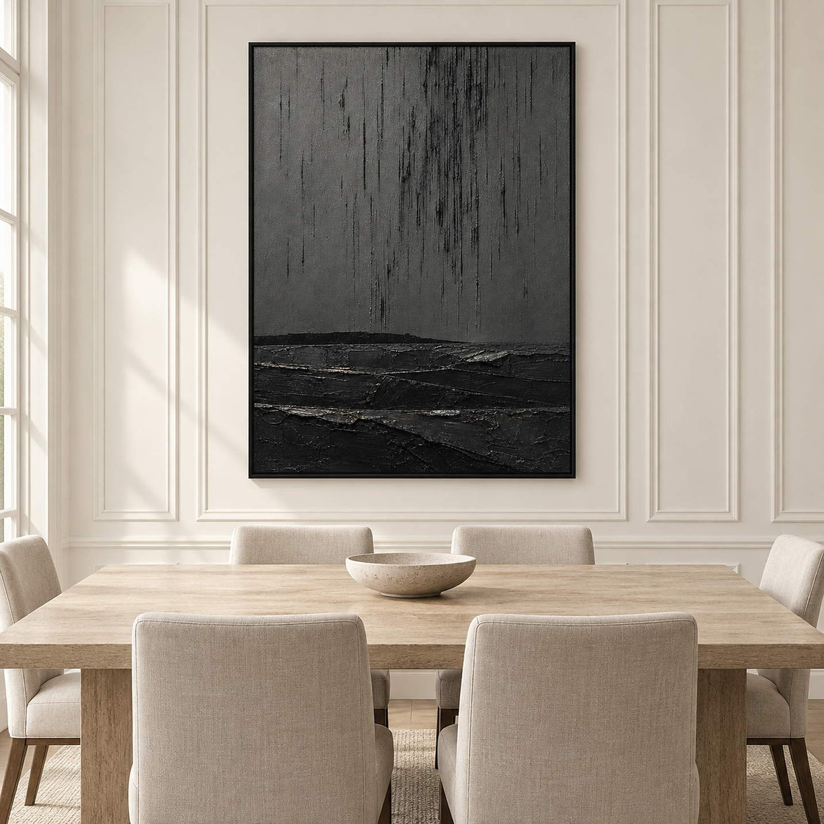 Charcoal rain marks descending over sculpted black terrain in a vertical composition, displayed in a dining room in a black frame.