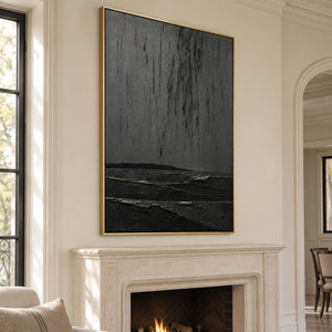 Charcoal rain marks descending over sculpted black terrain in a vertical composition, displayed beside or above a fireplace in a gold frame.