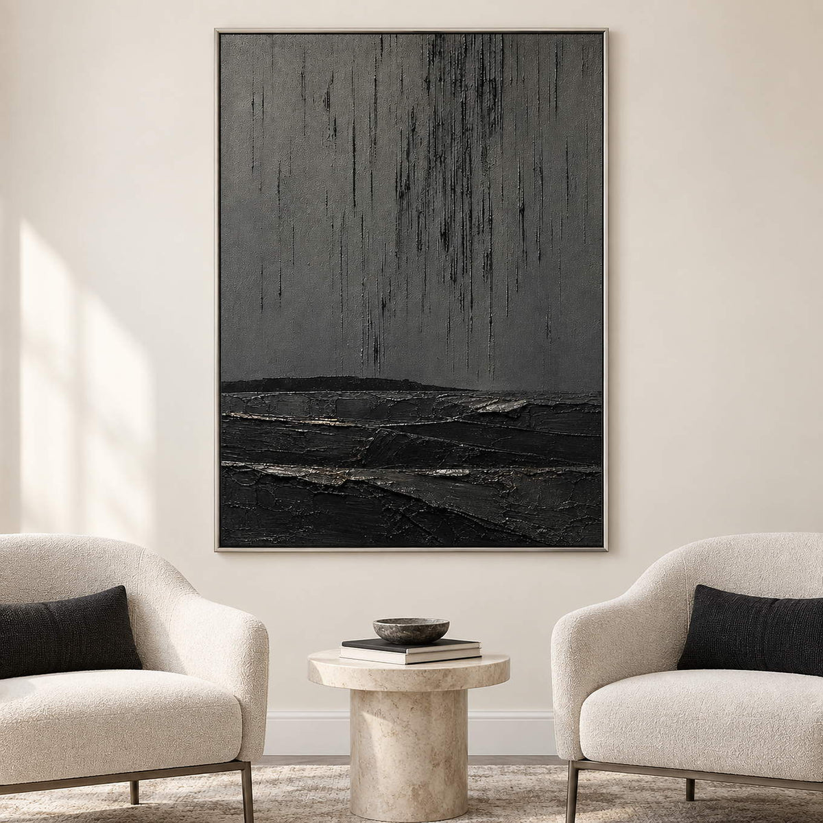 Charcoal rain marks descending over sculpted black terrain in a vertical composition, displayed in a lounge in a silver frame.