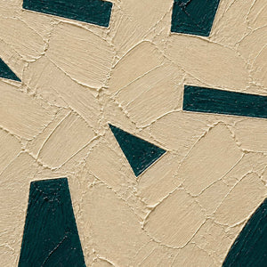 Close-up of raised ivory plaster and deep green geometric texture.