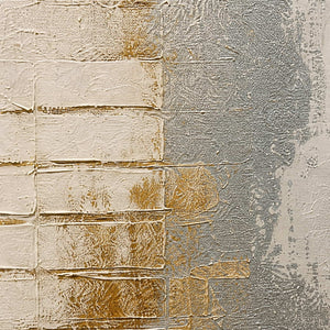 Close-up of raised ivory blocks, silver washes, and warm gold texture.