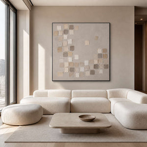 Textured neutral square wall art in a refined living room with a black frame.