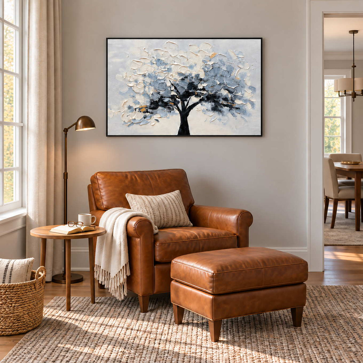 A Quiet Guardian in a black frame above a caramel leather armchair and matching footstool beside a tall window.