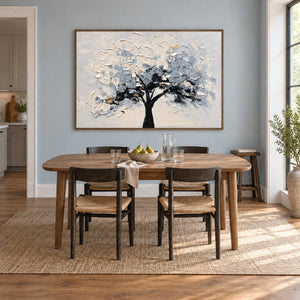 A Quiet Guardian in a brown wood frame above a wood dining table with dark chairs against a blue-gray wall.
