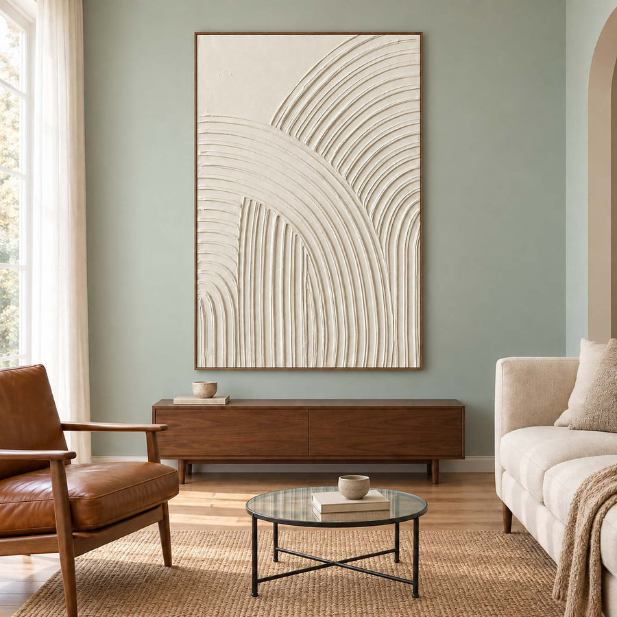 Ivory arc artwork on a green wall above a wooden cabinet.