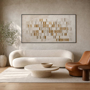 Gold textured abstract wall art above a cream modern living room.