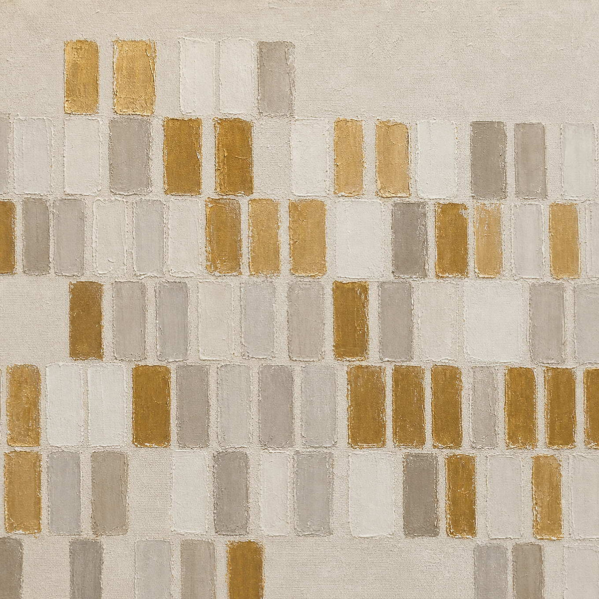 Close-up of raised ivory, gray, and metallic gold rectangular marks.