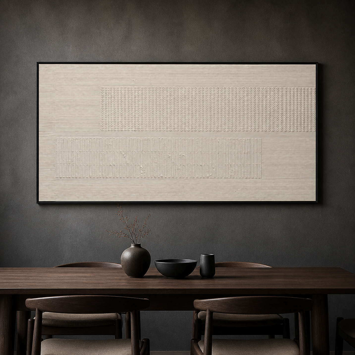Monochrome ivory relief artwork above a dark wood dining table.