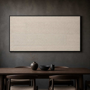 Monochrome ivory relief artwork above a dark wood dining table.