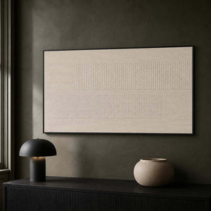 Textured ivory relief creating subtle contrast in a dark modern office.