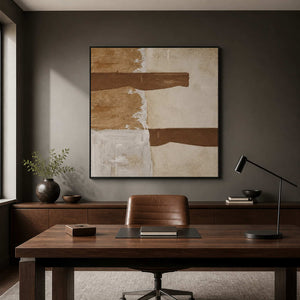 Black framed square painting with two horizontal brown strokes behind a study desk.