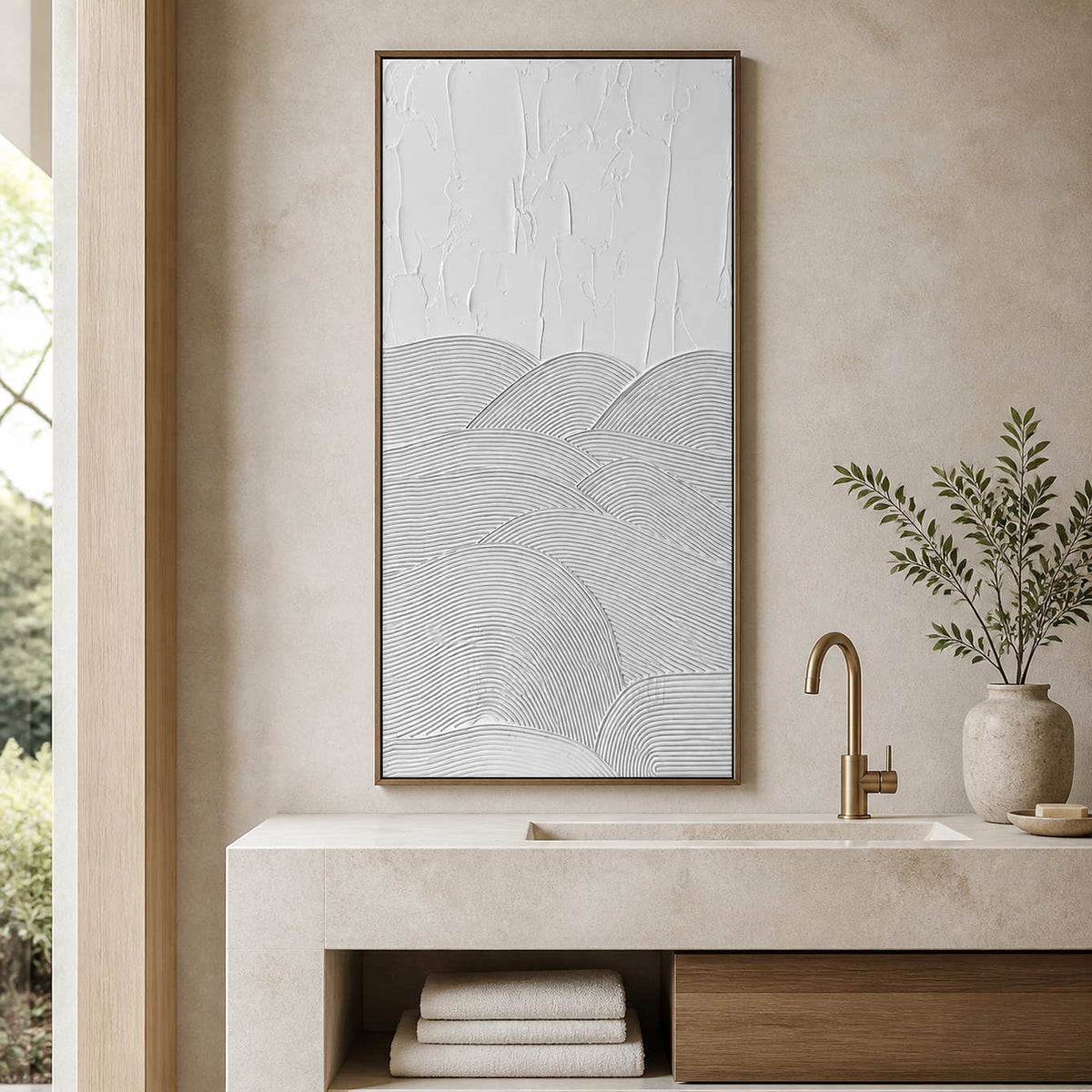 Wood framed white textured artwork above a pale stone bathroom vanity.