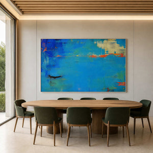Cobalt and orange abstract artwork above a contemporary dining table.