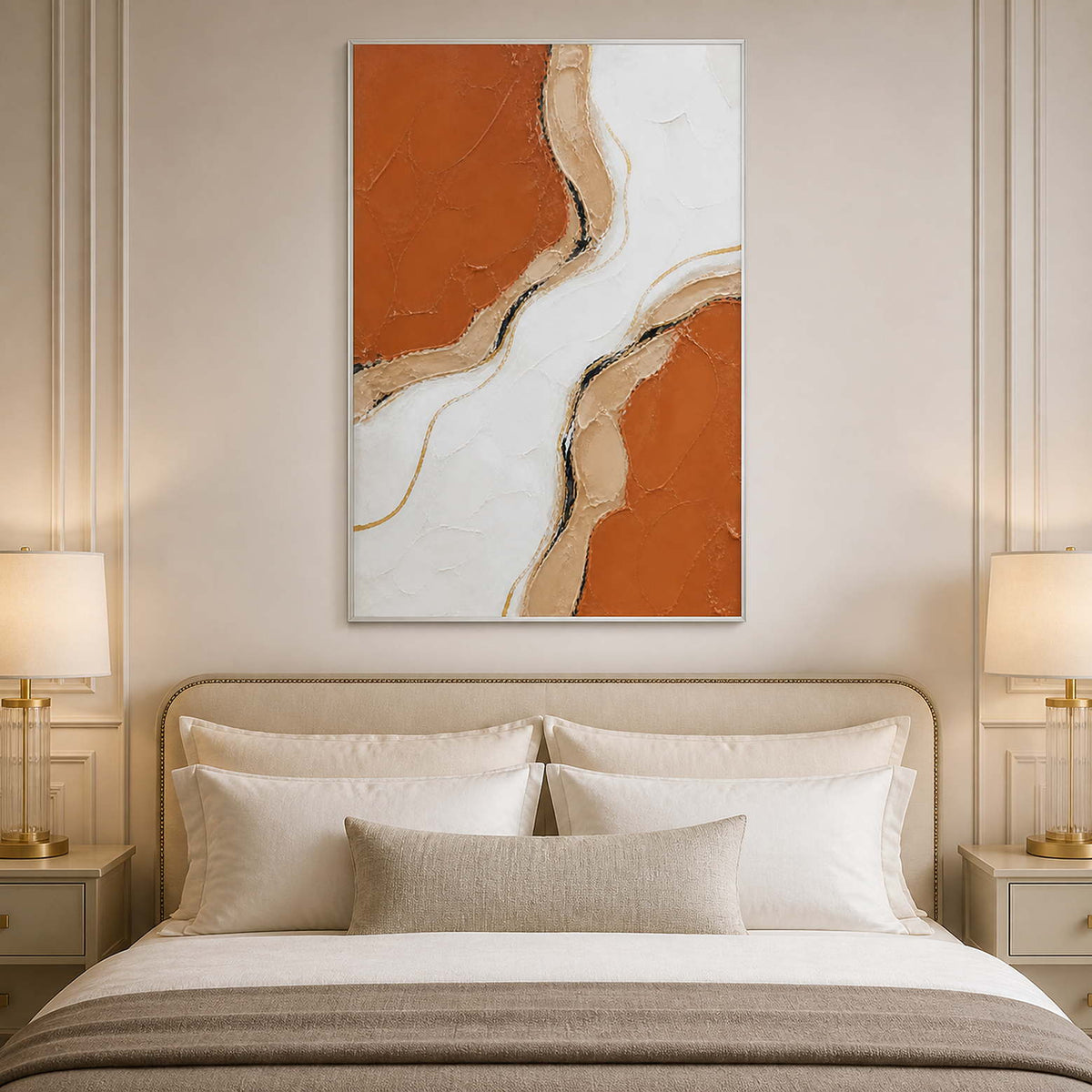 Terracotta and ivory abstract wall art styled above a neutral bed.