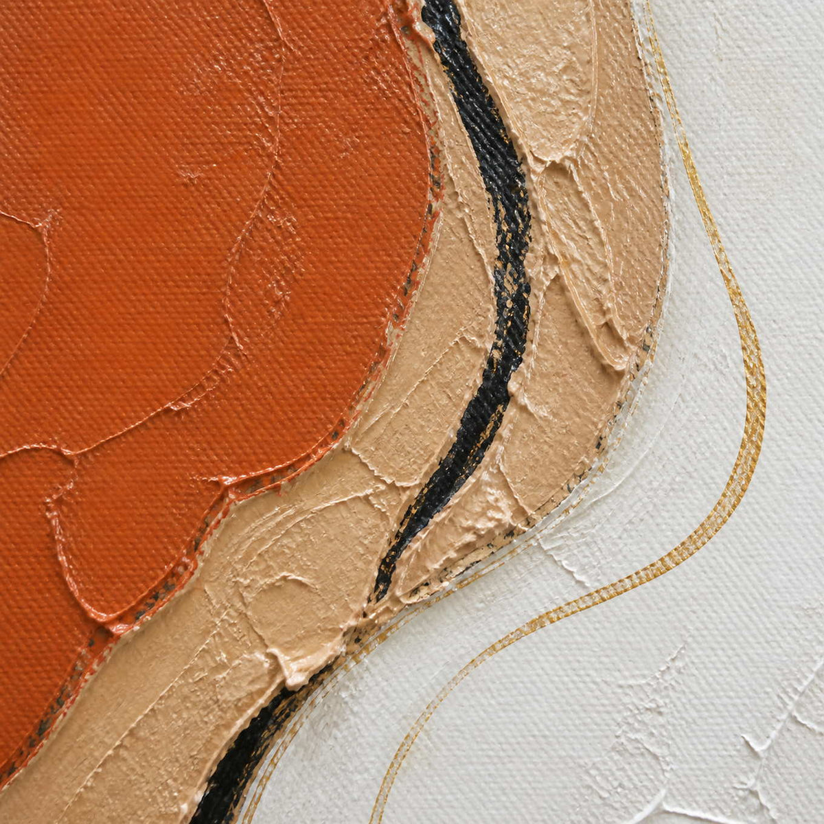 Close-up of terracotta, sand, charcoal, and gold layered paint texture.