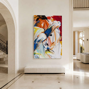 Colorful textured abstract canvas above a pale bench in a double-height entryway beside a staircase.
