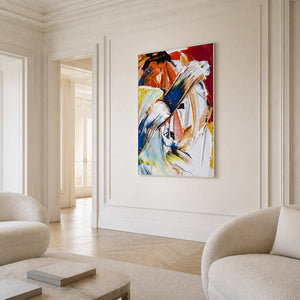 White-framed abstract painting with sweeping blue, white, and orange strokes in a bright formal living room.