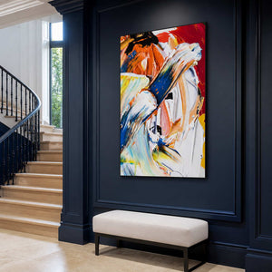Black-framed colorful abstract painting above an ivory bench on a navy-paneled wall beside a curving staircase.