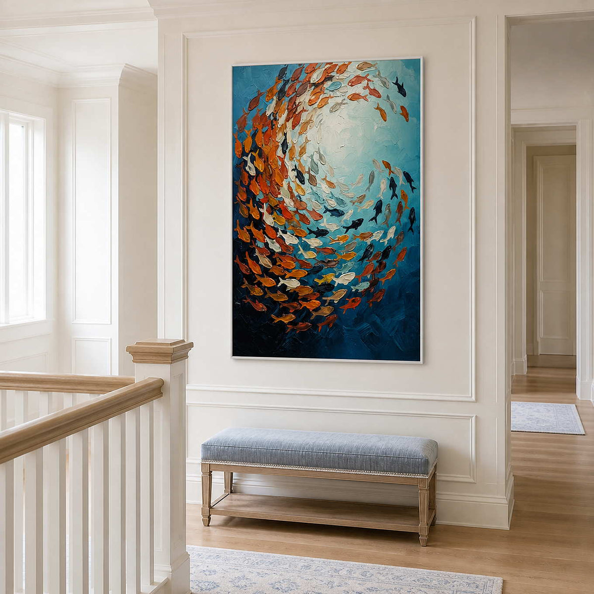 White framed fish artwork above a pale blue bench beside an upstairs stair railing.