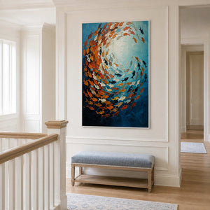 White framed fish artwork above a pale blue bench beside an upstairs stair railing.