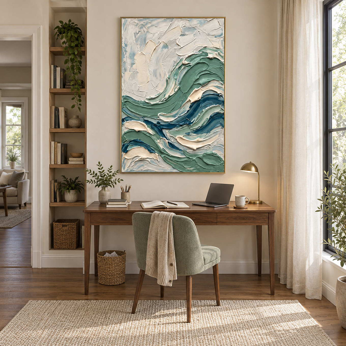 A Sea Breeze in a gold frame above a wood desk and muted green chair in a bright home study.