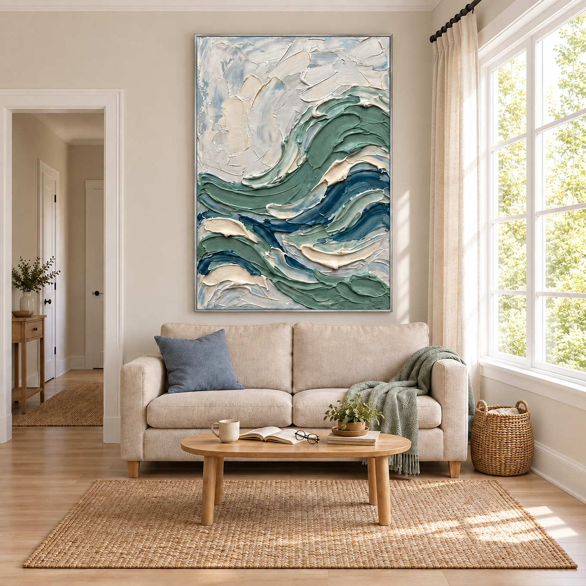 A Sea Breeze in a silver frame above a cream sofa in a bright living room with pale blue and green accents.