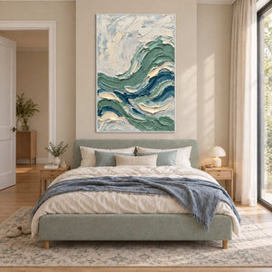 A Sea Breeze in a white frame above a pale green bed with a blue throw in a sunlit bedroom.