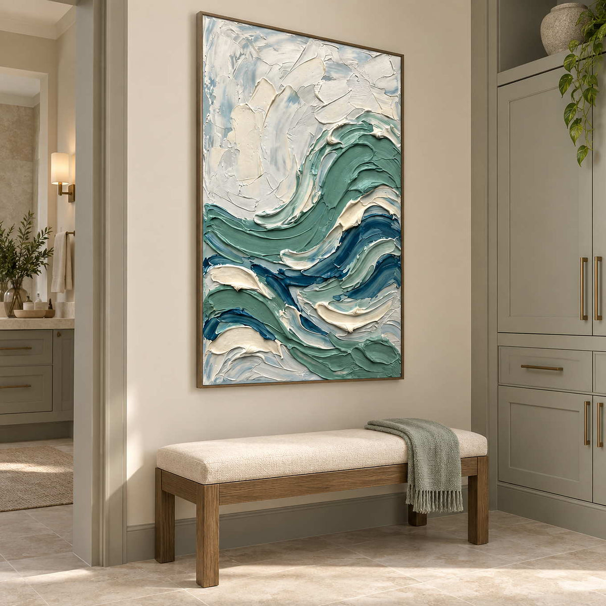 A Sea Breeze in a brown wood frame above a padded bench beside cabinetry in a neutral bathroom dry area.